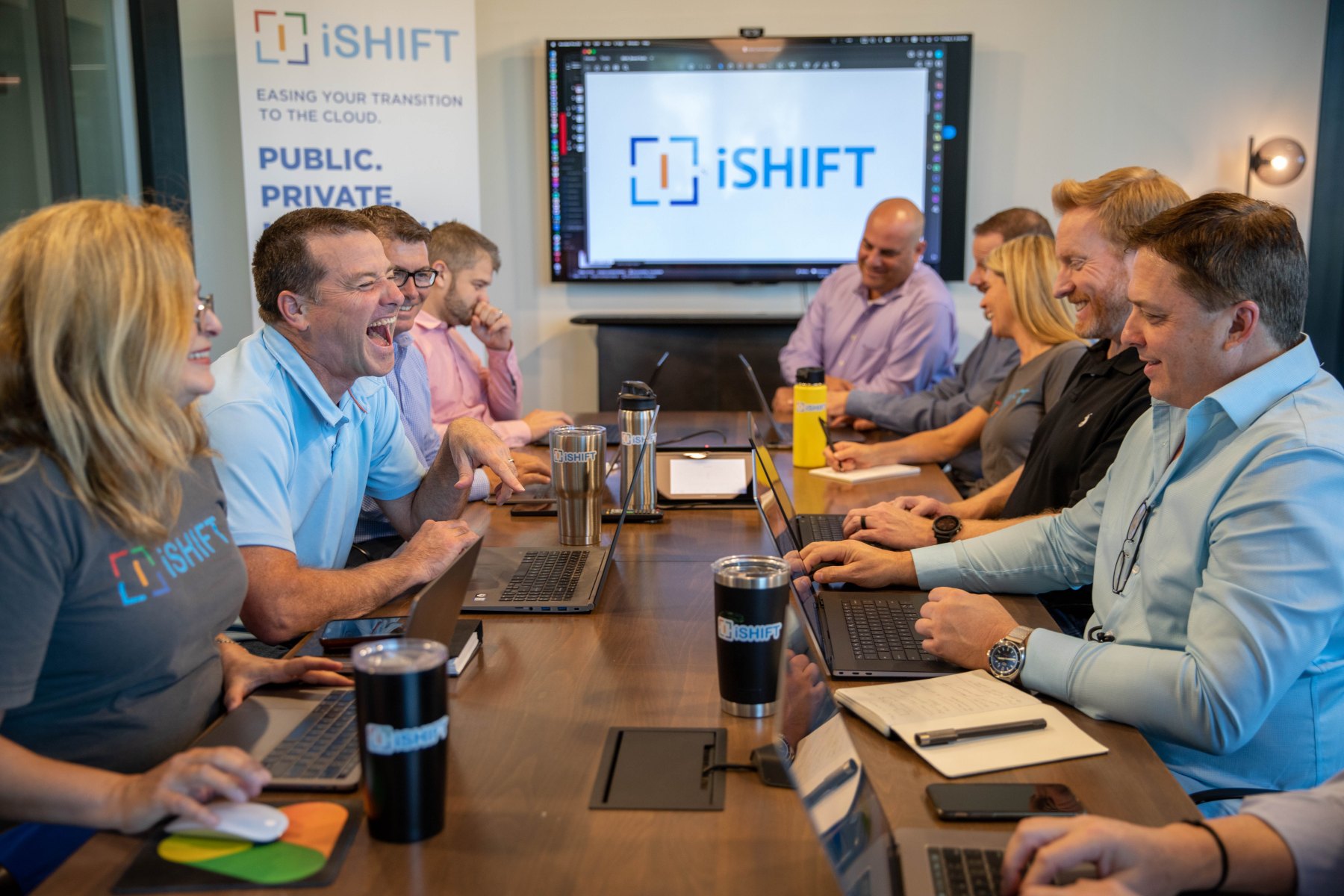 The iShift team working together around a conference table
