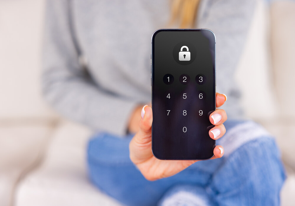 A passcode prompt on a phone held in both hands