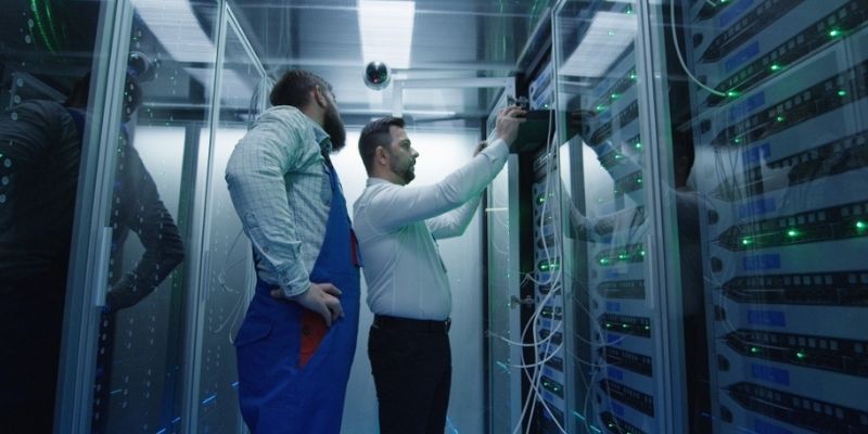 IT technician performing third-party maintenance on a legacy data center server.
